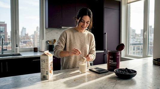 Woman mixing pea protein in bright kitchen