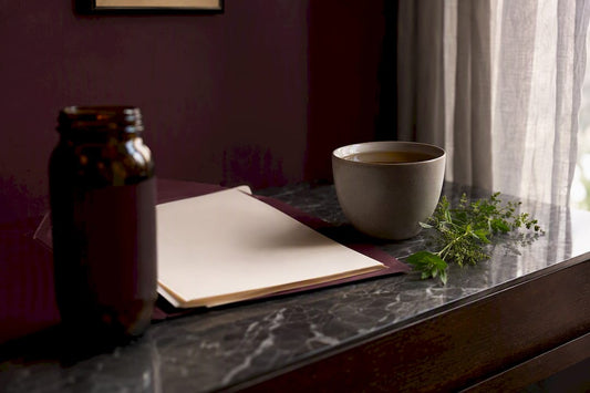 NMN supplement bottle with paperwork on dark plum table