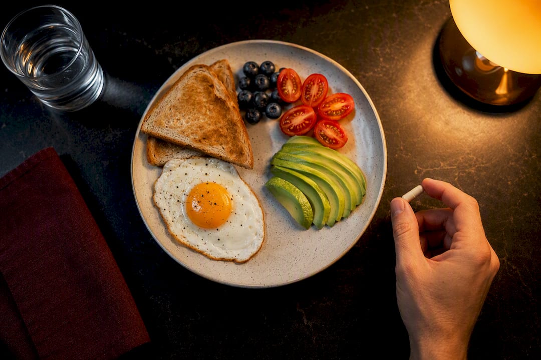 Anonymous capsule placed beside a meal